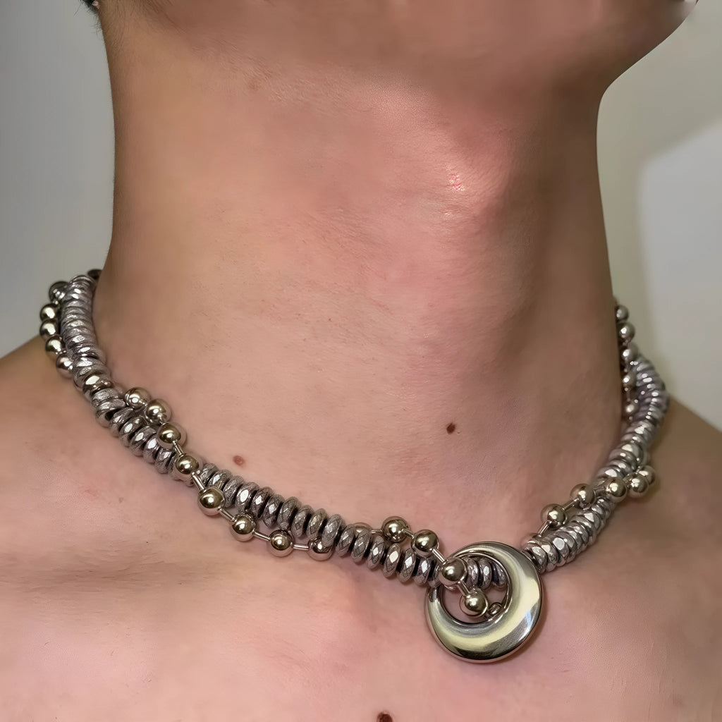 Silvery hand-woven titanium steel hip hop necklace with winding heavy industry chain texture on white background