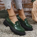 Women's black slip-on loafers with a chunky platform heel and mid-top ankle cut.