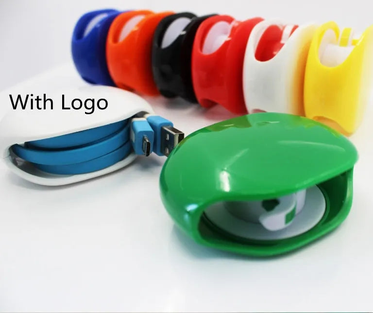 Compact automatic earphone winder in multiple colours on a grey background, showing extended cable.