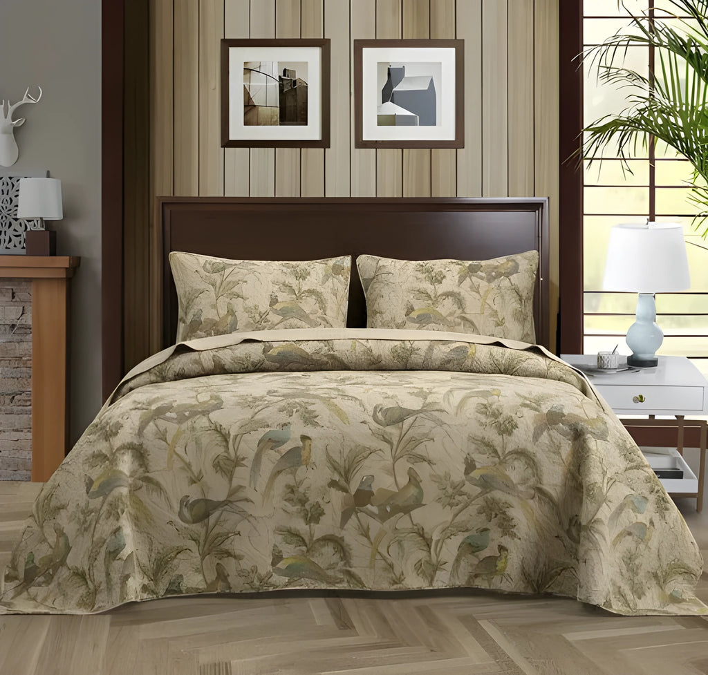 Blue American floral and bird pattern quilted cotton bedspread draped on a double bed