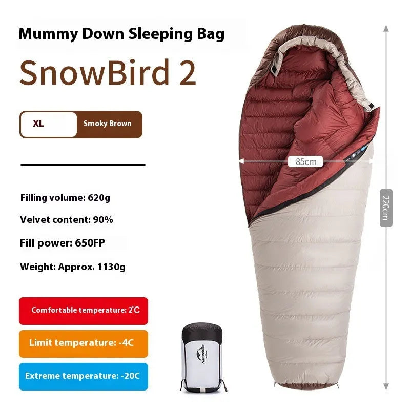 Adult mummy-style sleeping bag with goose down filler, shown with its storage bag
