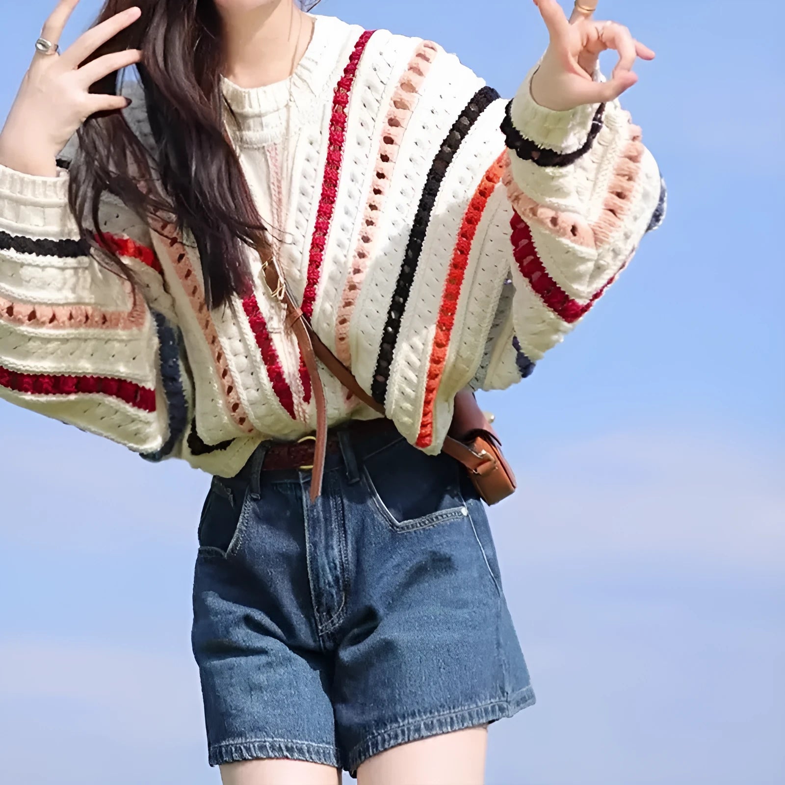 Colourful rainbow striped loose-fit pullover sweater with batwing sleeves and a round neck.