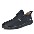 Men's black leather ankle boots with a front zipper and hand-stitched rubber sole.
