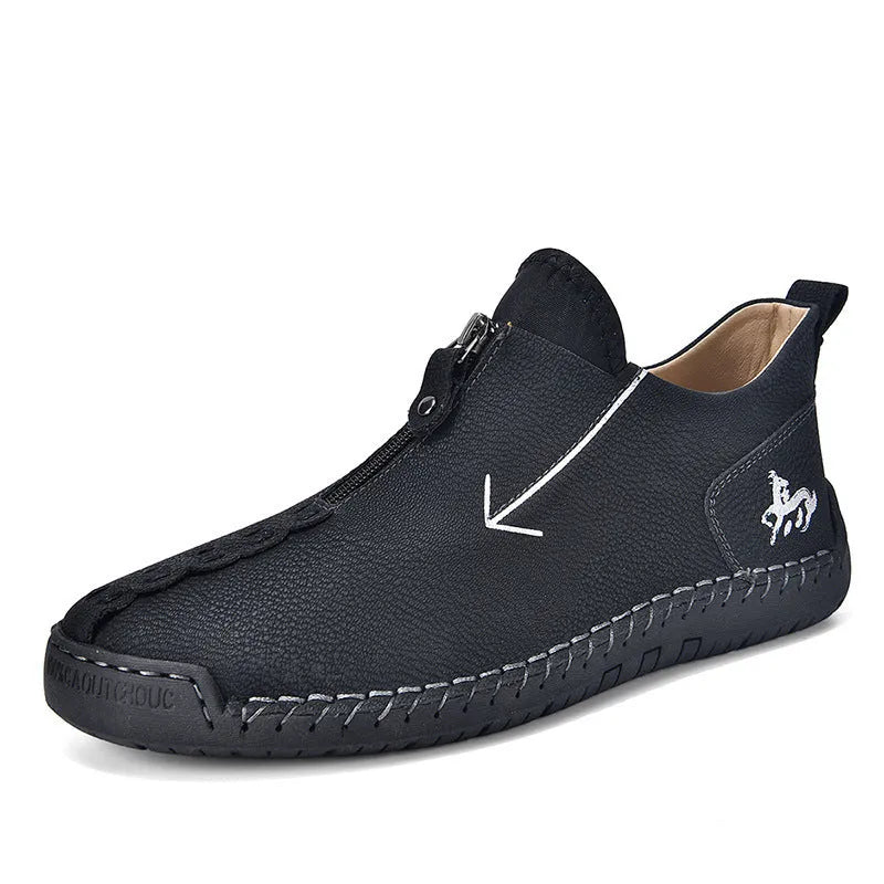 Men's black leather ankle boots with a front zipper and hand-stitched rubber sole.
