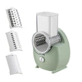 White electric vegetable slicer with rotary grater, suction base, and multiple blades on a kitchen counter.