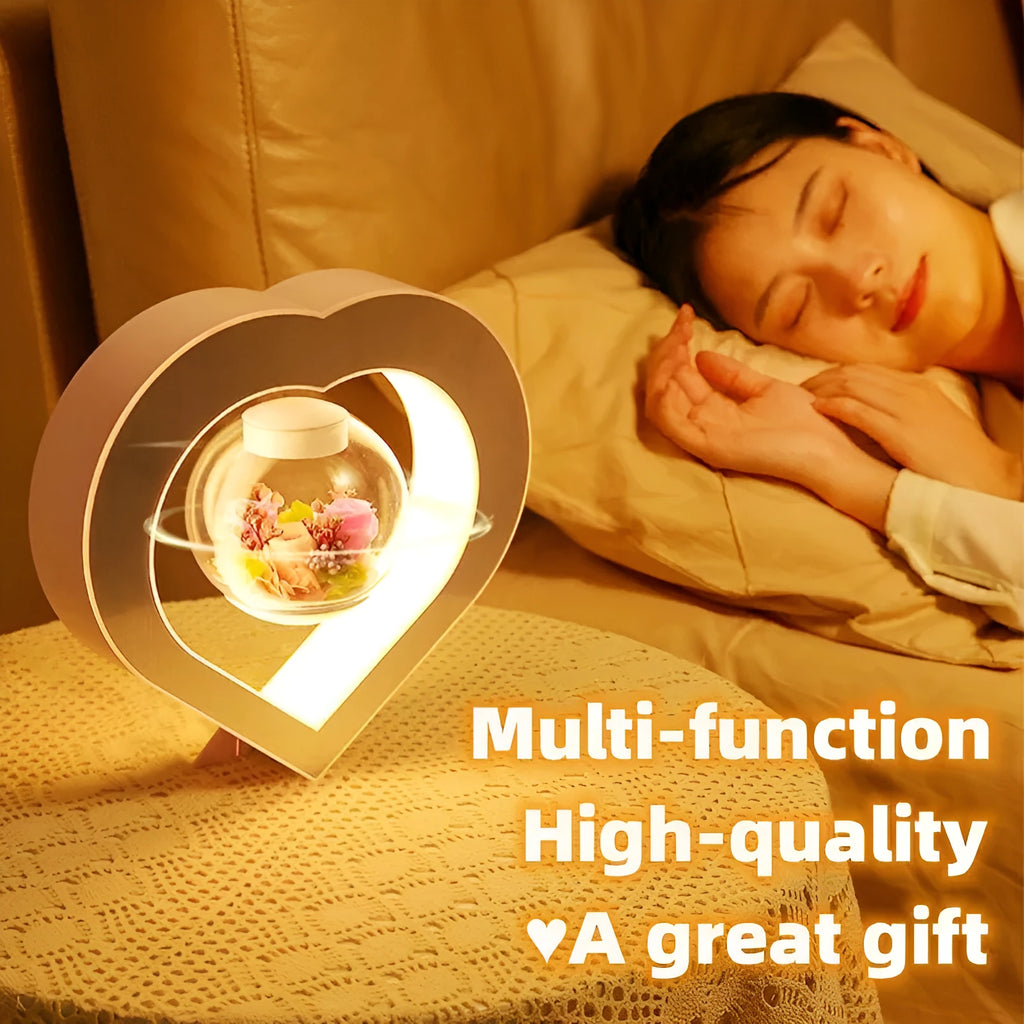 Pink floating heart LED levitation lamp with eternal flower on triangular base.