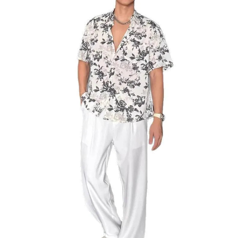 Man's loose black short sleeve shirt with a white floral print pattern.
