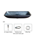Blue grey coloured tempered glass bathroom table basin with simple art design on a countertop.