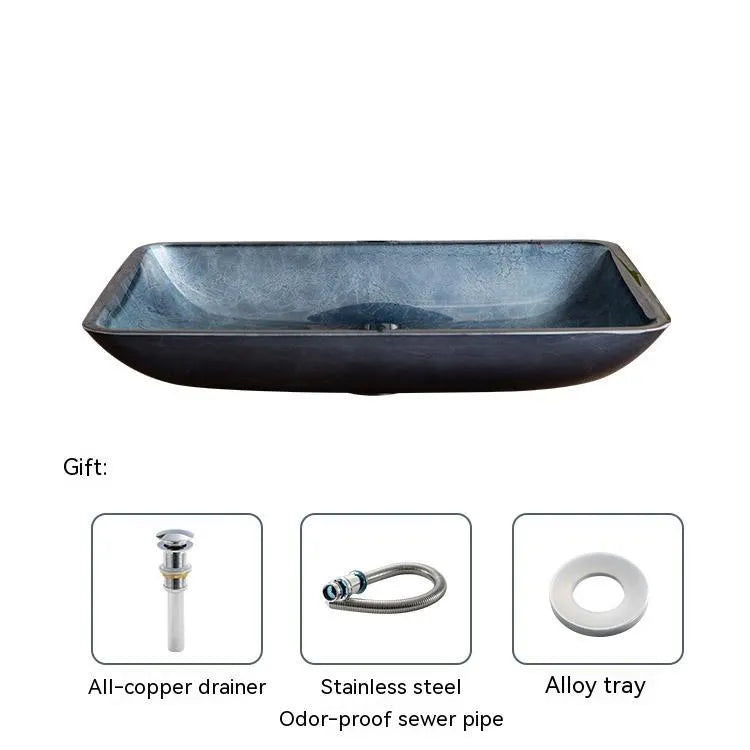 Blue grey coloured tempered glass bathroom table basin with simple art design on a countertop.