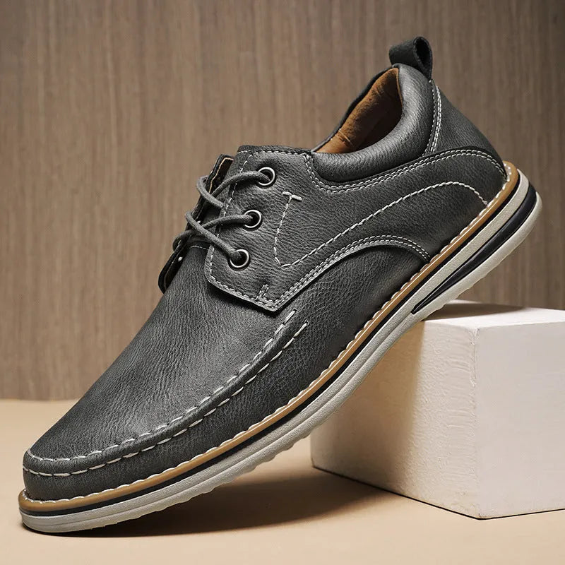 Men's black genuine leather lace-up casual shoes with round toe and rubber sole on a white background
