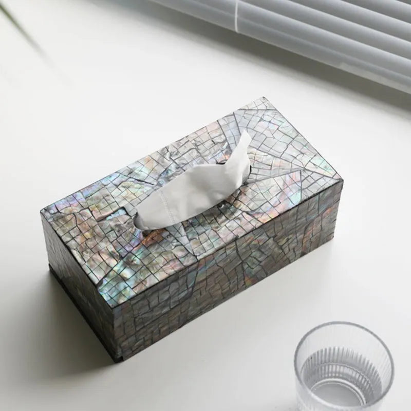 Black natural shell tissue storage box in rectangular and square shape options on a coffee table.