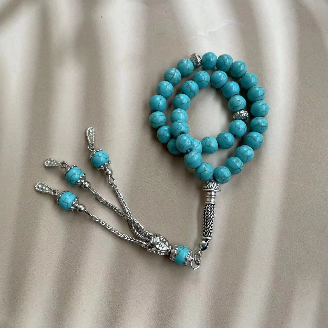 Handmade Muslim prayer bracelet made of sky blue 8mm stone beads on a wrist.
