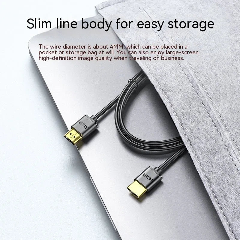 Gold-plated HDMI to HDMI cable with thin flexible wire on a white background.