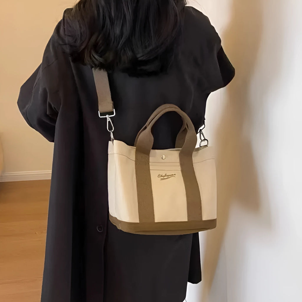 Beige canvas messenger bag with three shoulder straps and sandwich pocket for outdoor and everyday use