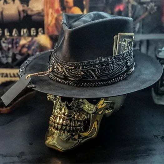 Handmade conical skull hat in wool felt and denim, shown from the side, highlighting its structured crown shape.