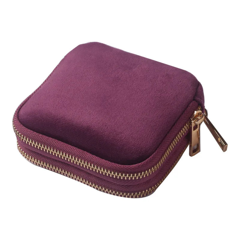 Blue PU zippered jewellery storage bag in handbag shape, 11x11x3.5cm, on a travel background
