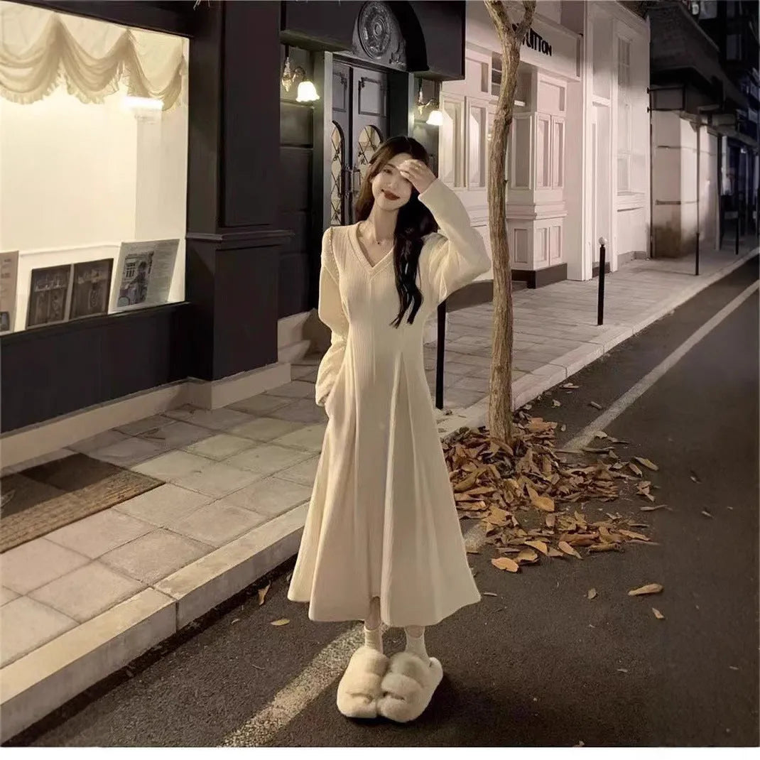 Women's V-neck knitted dress with princess sleeves in milky white colour showing long skirt length