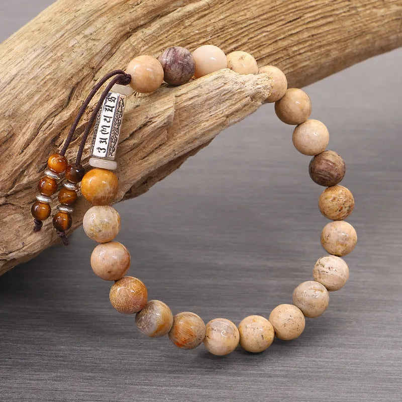 Handmade wood colour stone bead bracelet with adjustable closure on wooden background