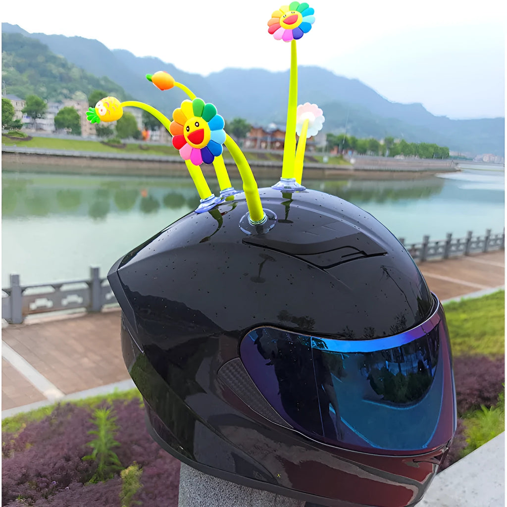 Yellow silicone sunflower helmet decoration with swinging stem and suction cup on a visor.