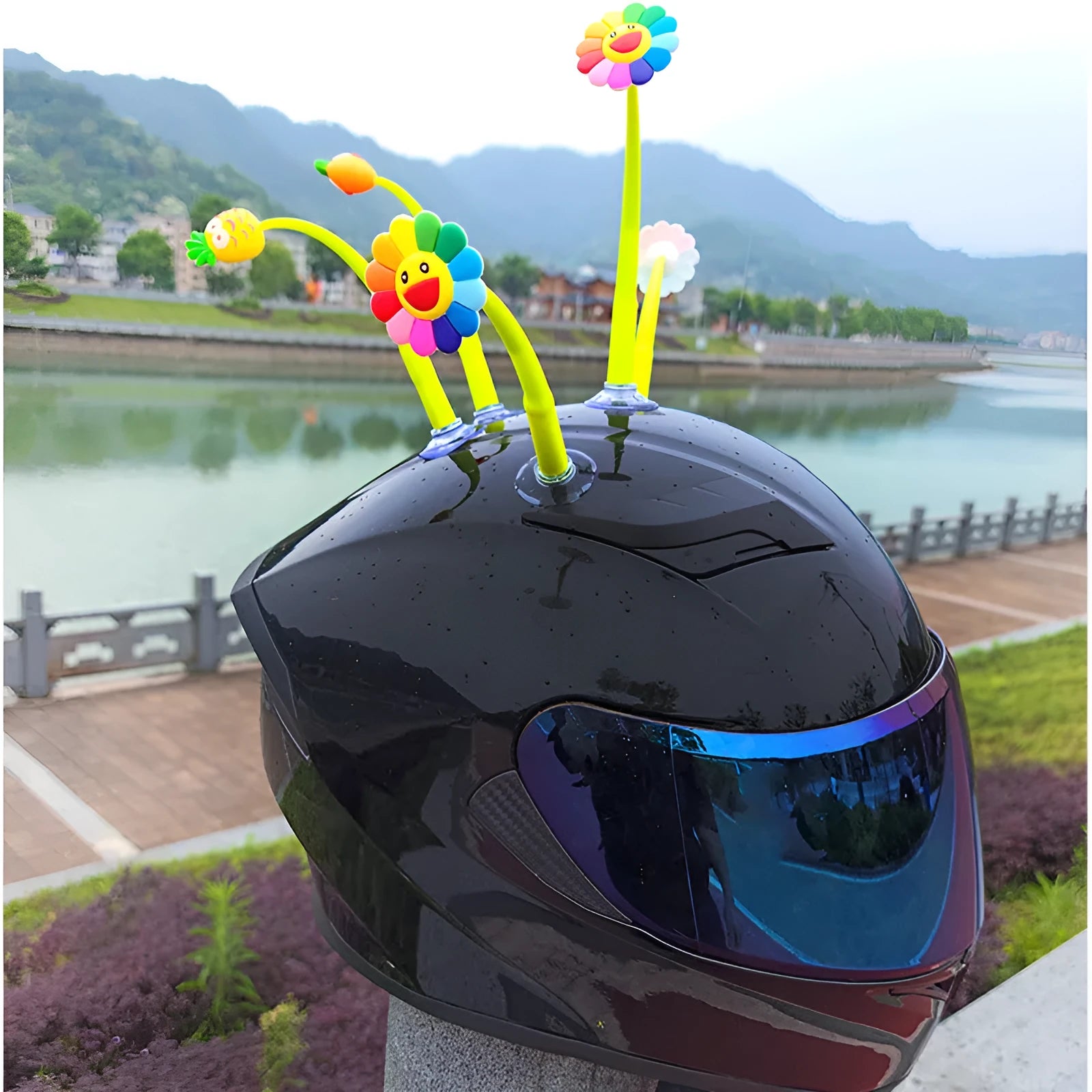 Yellow silicone sunflower helmet decoration with swinging stem and suction cup on a visor.