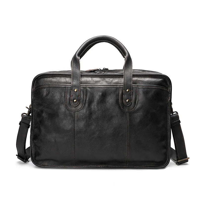 Brown vintage leather men's briefcase with soft handle, showing organised internal pockets for laptop and camera.