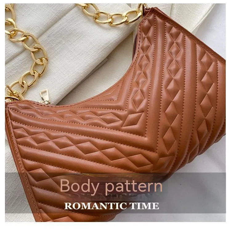 Brown pleated PU baguette shoulder bag with a top handle and long chain strap on a white background.