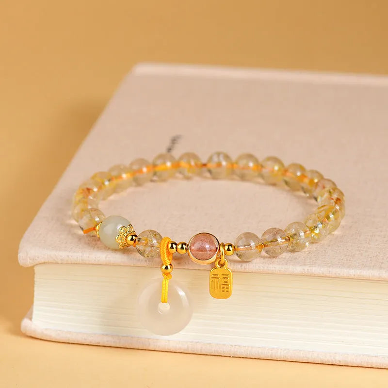 Gold rutilated quartz geometric crystal bracelet with peace buckle safety clasp and pendant charm