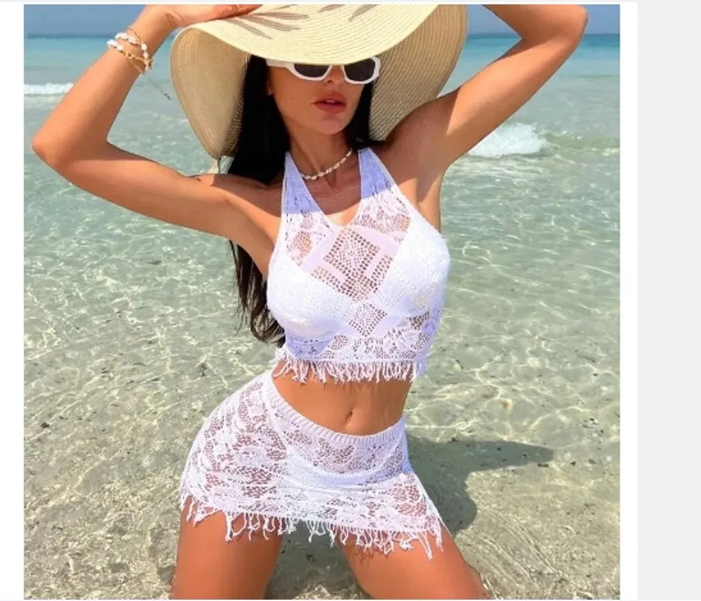 Women's white lace-up bikini set with matching tassel skirt for beach wear