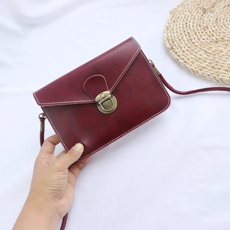 Soft retro cross square flap messenger bag in wine red, shown with lock detail and crossbody strap.