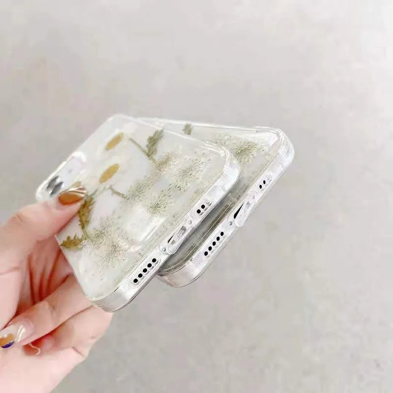 White TPU iPhone case with a raised epoxy daisy floral design on the back.