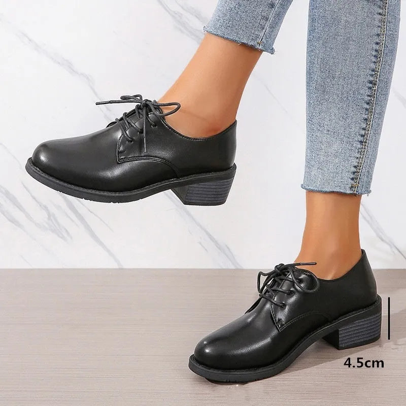 Black women's work shoes with a chunky heel, round toe, and low top design on a rubber sole.