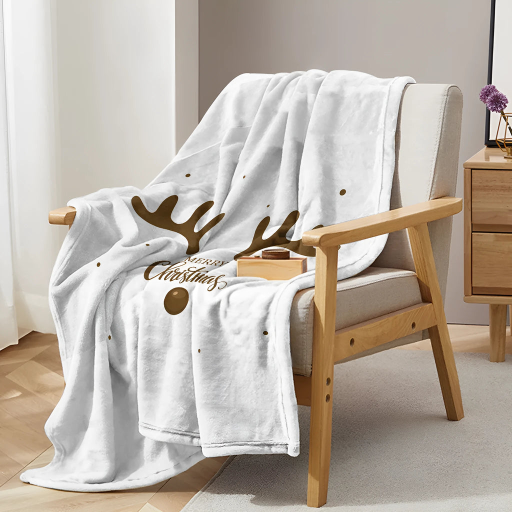 Deer antler pattern Christmas limited edition white flannel velvet blanket on a sofa