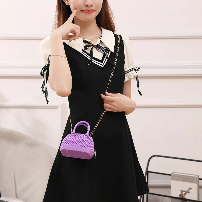 Translucent PVC jelly shell handbag with hollowed design and metal chain strap in apricot colour