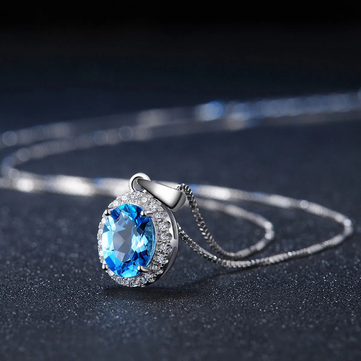 925 sterling silver blue topaz jewellery set showing necklace, ring, earrings and pendant with geometric design