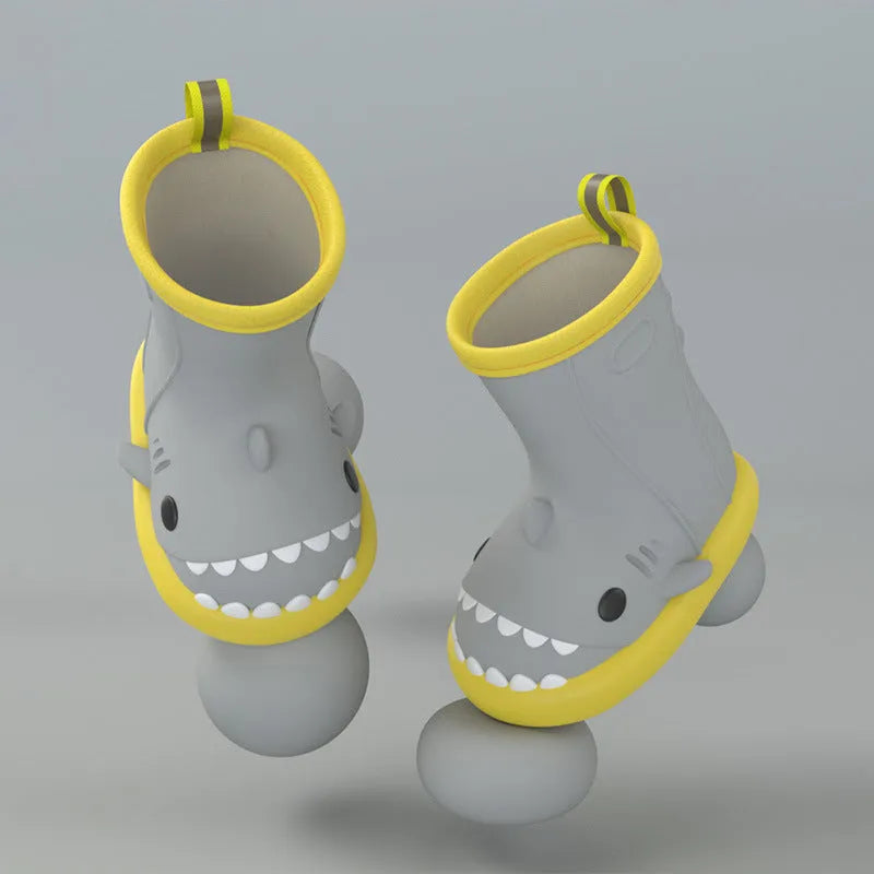 Shark and dinosaur design children's rain boots in green, available in multiple colours and sizes.