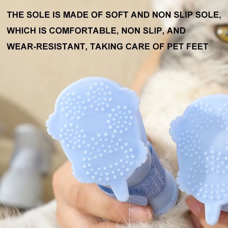 Set of four waterproof silicone dog rain boots in dark blue, gray, light blue, and pink on a white background