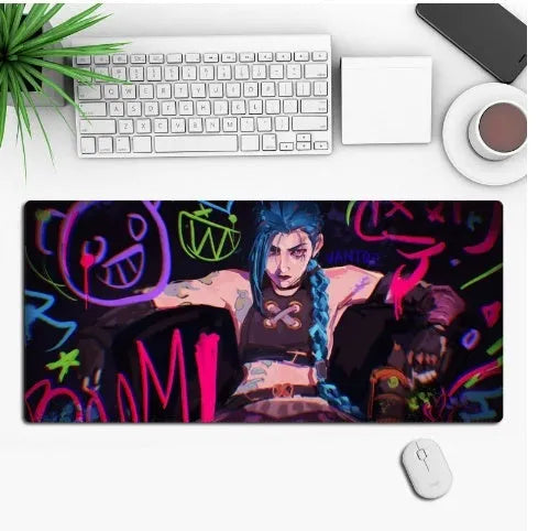 Large black anime-themed gaming mouse pad with non-slip rubber base on a wooden desk.