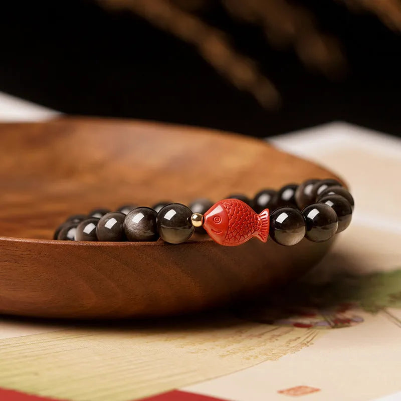 Natural obsidian bracelet with round cinnabar beads in three size options on a wrist