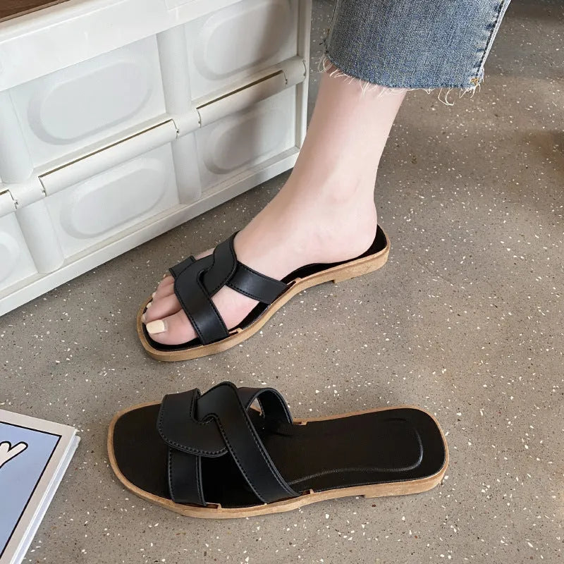 Women's white PVC cross strap toe ring sandals on a plain background