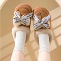 Women's beige suede half slippers with a ribbon bow and thick sole.