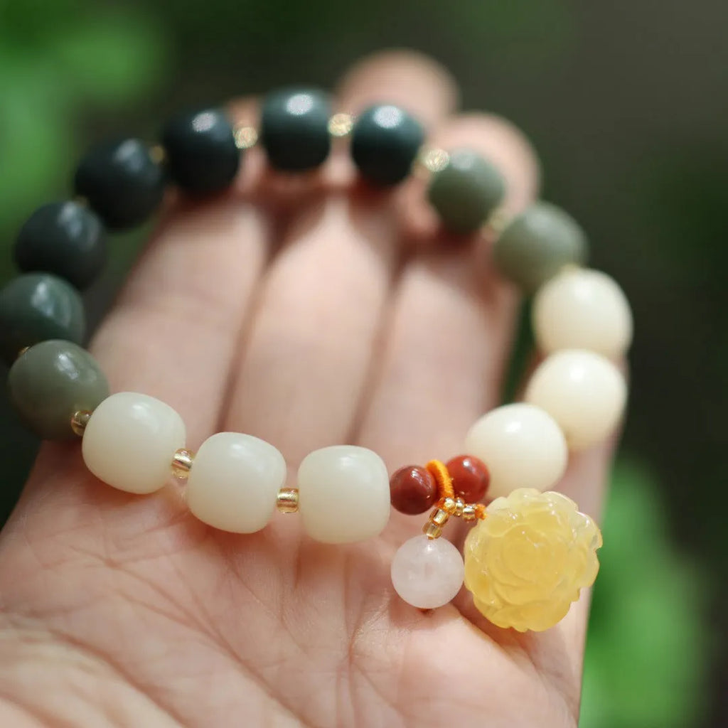 Woven bodhi bracelet with gradient white jade beads and natural beeswax lotus pendant on wrist
