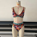 Women's high-waist floral print bikini set in blue on a mannequin.