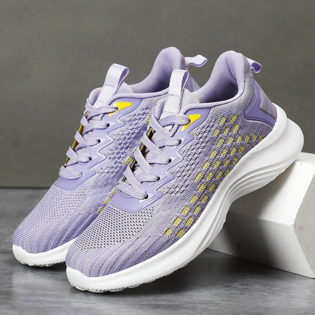 Women's Lavender Purple Flyknit running shoes with mesh detailing and a striped pattern on a white background.