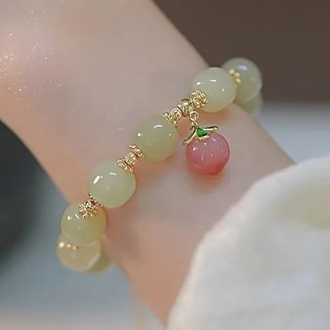 A glass and coloured glaze bracelet with a rabbit motif and a peace buckle clasp.