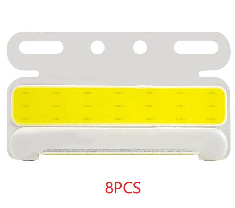 Waterproof aluminium alloy LED side light for trucks, showing bright COB illumination in blue, mounted near a vehicle tyre.