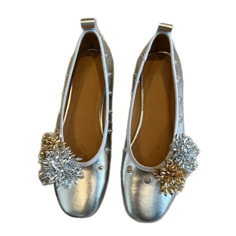 Silver Mary Jane buckle flats with DIY flower rivets on the strap, showing round toe and low top profile.