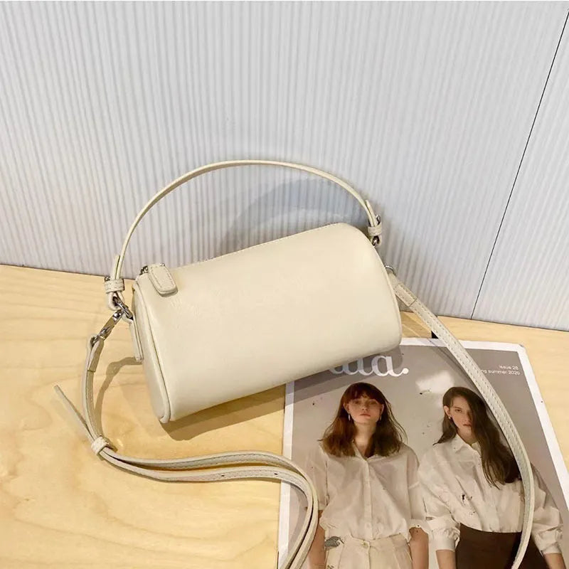 Genuine leather mobile phone crossbody bag with cylindrical design in six colour options showing sewing thread detailing