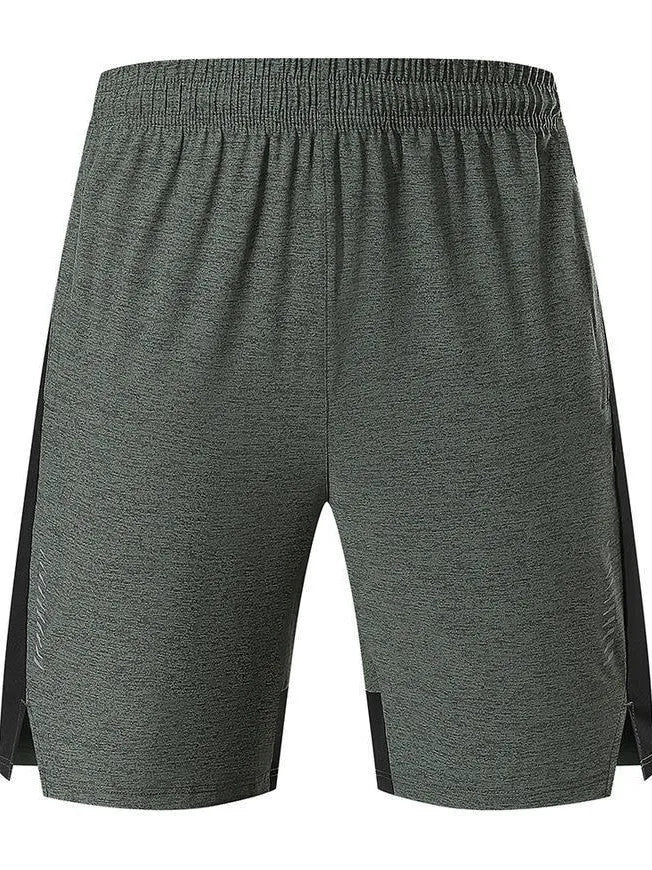 Man wearing mid-waist forest green spandex shorts, showcasing the casual fit and short length.