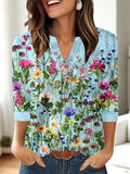 Women's loose-fit grey V-neck top with a white 3D geometric pattern print on the front.