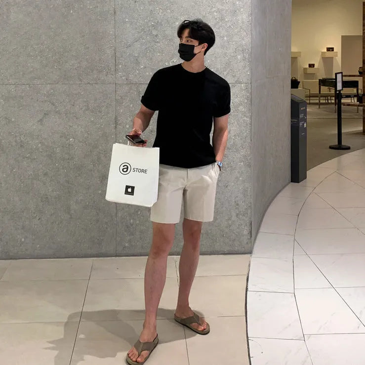 Men's straight leg casual shorts in solid colour on a hanger